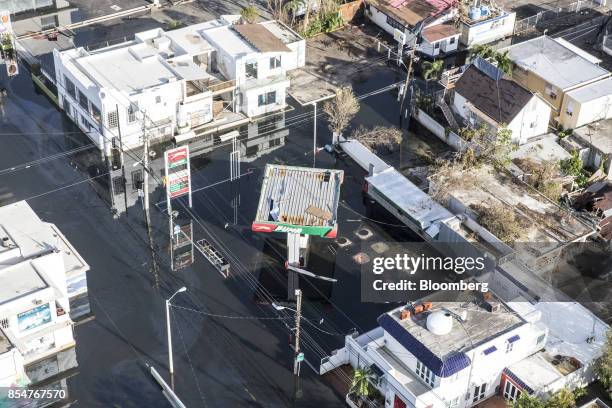 Gas station and homes stand in floodwater from Hurricane Maria in this aerial photograph taken above Barrio Obrero in San Juan, Puerto Rico, on...