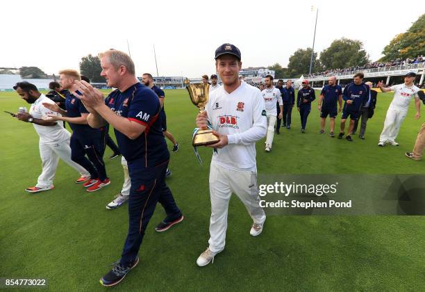 Tom Westley of Essex lifts the County Championship trophy during day three of the Specsavers County Championship Division One match between Essex and...