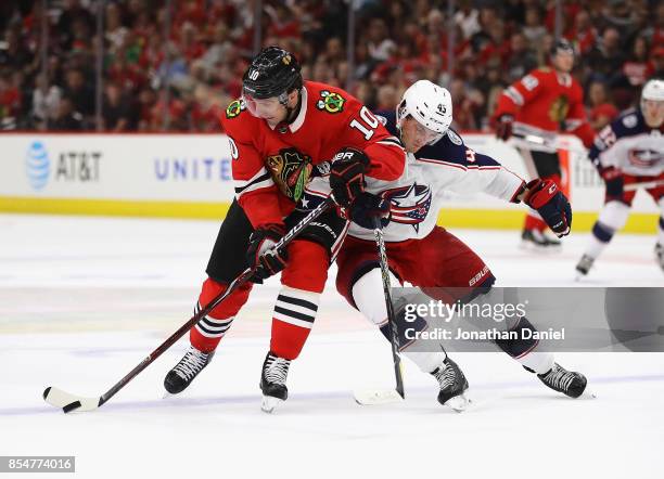 Patrick Sharp of the Chicago Blackhawks is pressured by Lukas Sedlak of the Columbus Blue Jackets as he advances the puck during a preseason game at...