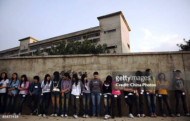 Workers who are being sent to work in a factory prepare to receive a physical exam at the Shenzhen Quanshun Human Resources Co. Ltd. On February 26,...