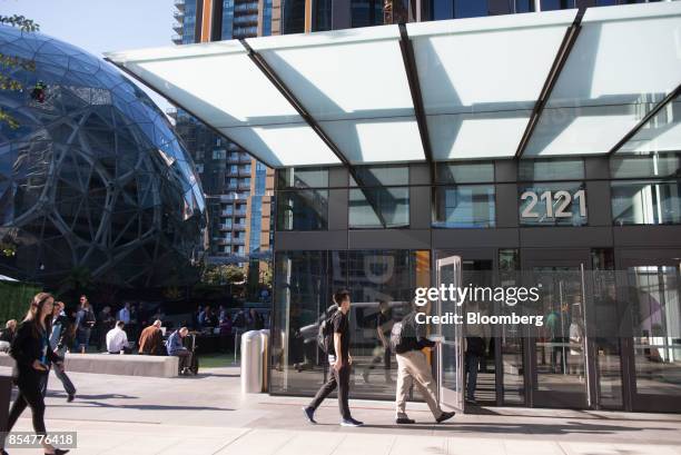 Attendees arrive at the Amazon.com Inc. Day 1 building ahead of the company's product reveal launch event in downtown Seattle, Washington, U.S., on...