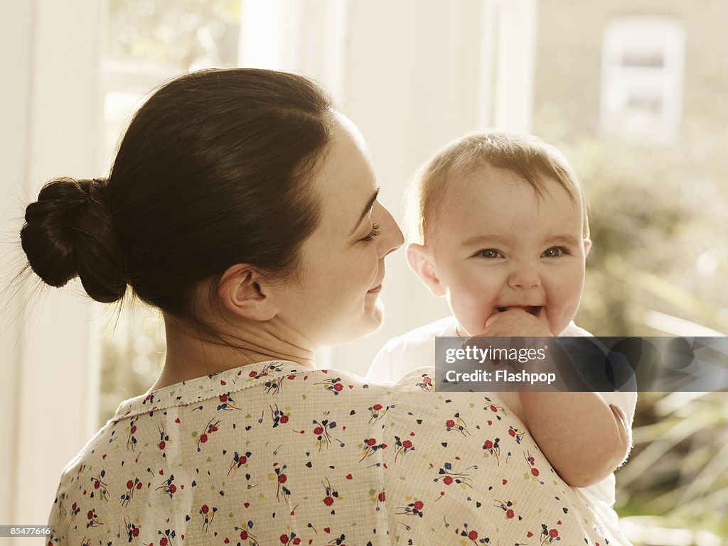 Portrait of woman holding baby