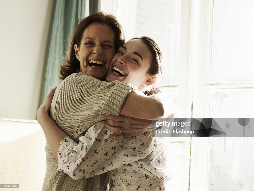Portrait of mother and daughter embracing