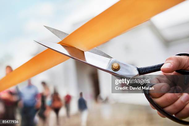 scissors cutting ribbon, building in background - ribbon cutting stock pictures, royalty-free photos & images