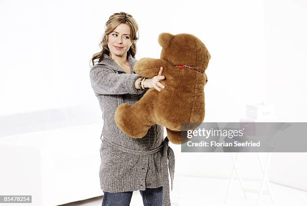 Bettina Cramer poses pregnant of seven months with a teddy bear on January 15, 2009 in Berlin, Germany. The TV presenter gave birth to her twins...