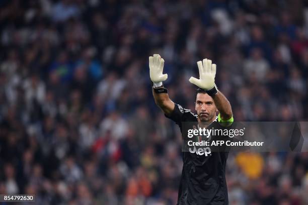 Juventus' goalkeeper from Italy Gianluigi Buffon greets fans before the UEFA Champion's League Group D football match Juventus vs Olympiacos on...