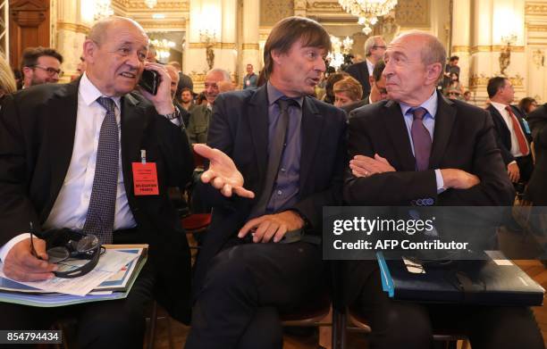 French Foreign Affairs Minister Jean-Yves Le Drian speaks with French Minister for the Ecological and Inclusive Transition Nicolas Hulot and French...