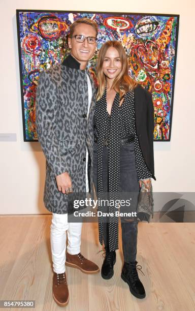 Ollie Proudlock and Emma Louise Connolly attend the private view and launch of Sacha Jafri's 18 year retrospective global tour "Universal...