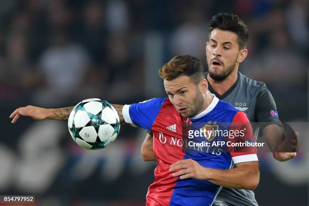 Basel's Swiss midfielder Renato Steffen and Benfica's midfielder Pizzi vies for the ball during the UEFA Champions league Group A football match...