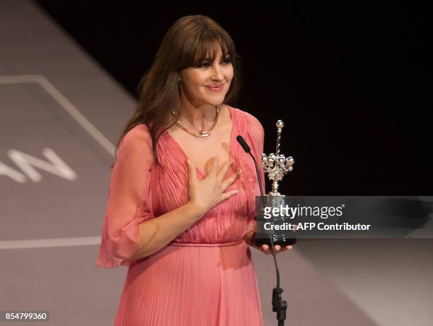 Italian actress Monica Bellucci holds her Donostia Award for her prestigious film career during the 65th San Sebastian Film Festival, in the northern...