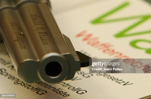 Smith & Wesson Magnum gun and a firearms law book are seen in a gun store on March 18, 2009 in Hamburg, Germany. The recent shooting in the German...