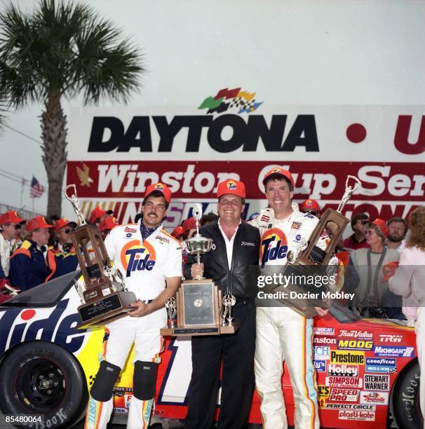 Driver Darrell Waltrip celebrates in Victory lane with crew chief Jeff Hammond and car owner Rick Hendrick after winning the Daytona 500 race on...