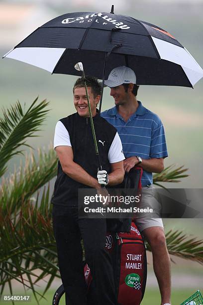 Stuart Manley of Wales shelters under an umbrella during the Madeira Islands Open BPI previews at the Porto Santo Golfe Club on March 18, 2009 in...