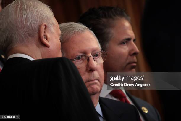Senate Finance Committee chairman Sen. Orrin Hatch whispers to Senate Majority Leader Mitch McConnell during a press event to discuss the GOP plans...