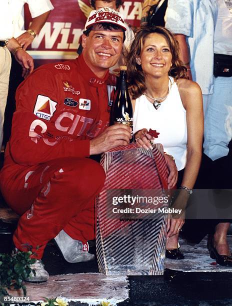 Driver Michael Waltrip smiles with trophy and wife Buffy Waltrip after winning the 1996 The Winston Select race on May 20, 1996 at the Charlotte...