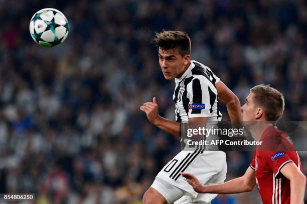 Juventus' forward from Argentina Paulo Dybala heads the ball during the UEFA Champion's League Group D football match Juventus vs Olympiacos on...