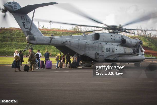 In this handout imade provided by the U.S.Navy, U.S. Citizens board a U.S. Marine Corps CH-53E Super Stallion helicopter assigned to Joint Task Force...