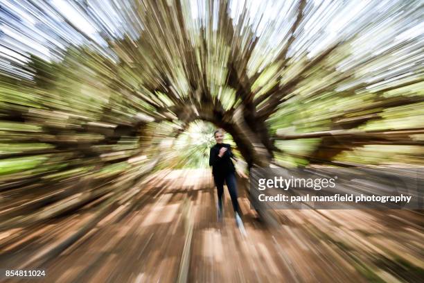 mature lady running through woodland - zoom in stock pictures, royalty-free photos & images