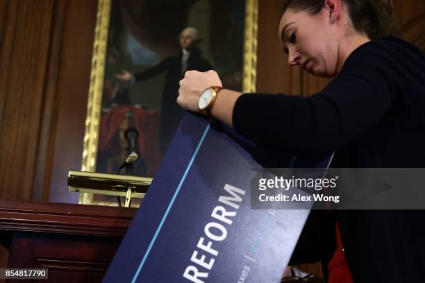 Congressional aide takes the sign off after a press event on tax reform September 27, 2017 at the Capitol in Washington, DC. On Wednesday, Republican...