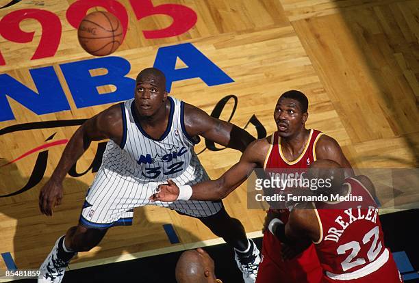 Shaquille O'Neal of the Orlando Magic battles for position against Hakeem Olajuwon of the Houston Rockets during Game One of the 1995 NBA Finals...
