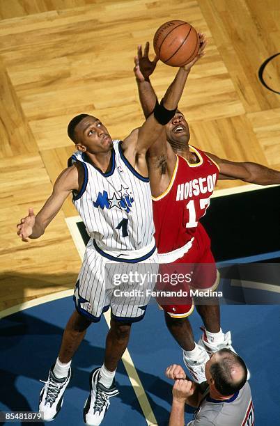 Anfernee Hardaway of the Orlando Magic battles for the rebound against Mario Elie of the Houston Rockets during Game One of the 1995 NBA Finals...