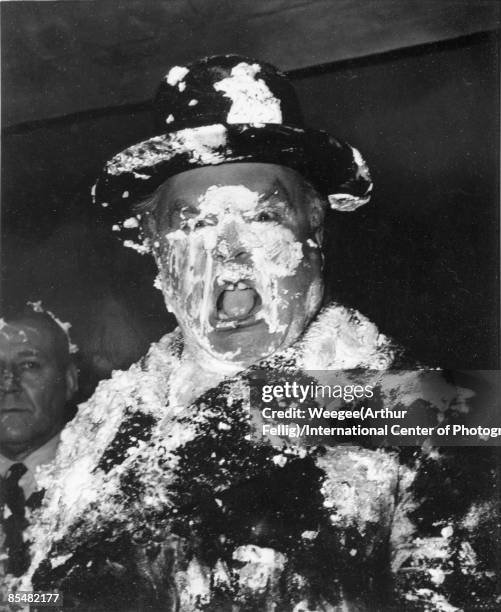 Man's face is covered in cream as a result of a pie fight in the War Room on the set of Stanley Kubrick's movie 'Dr. Strangelove, Or How I Learned to...