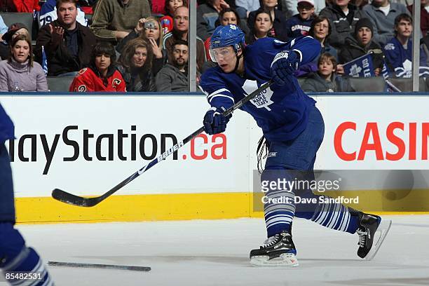 Luke Schenn of the Toronto Maple Leafs shoots the puck against the Calgary Flames during the game at Air Canada Centre on March 14, 2009 in Toronto,...