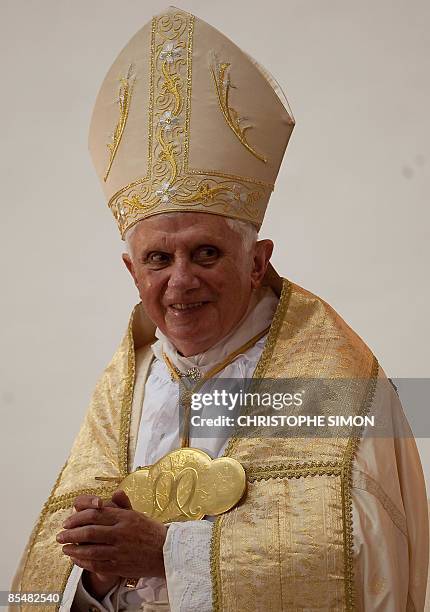 Pope Benedict XVI is pictured smiling at the Basilic "Mineur, Marie reine des apotres" on March 18, 2009 in the capital Yaounde on the second day of...