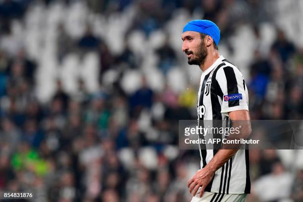 Juventus' defender from Italy Giorgio Chiellini has his head wrapped with a blue bandage after an injury during the UEFA Champion's League Group D...