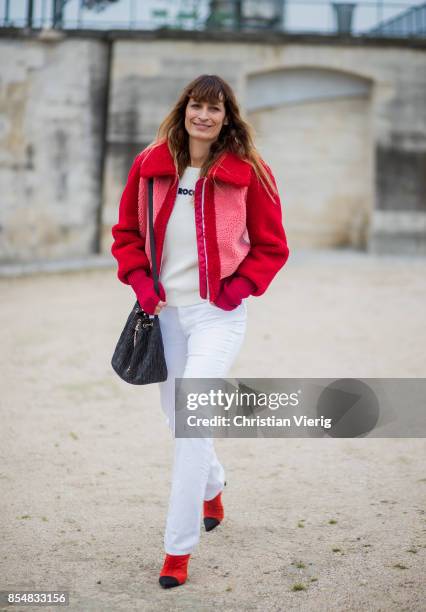 Caroline de Maigret wearing red teddy jacket, white pants is seen outside Lacoste during Paris Fashion Week Spring/Summer 2018 on September 27, 2017...