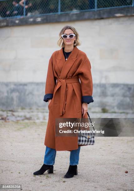 Anne-Laure Mais wearing brown coat is seen outside Lacoste during Paris Fashion Week Spring/Summer 2018 on September 27, 2017 in Paris, France.