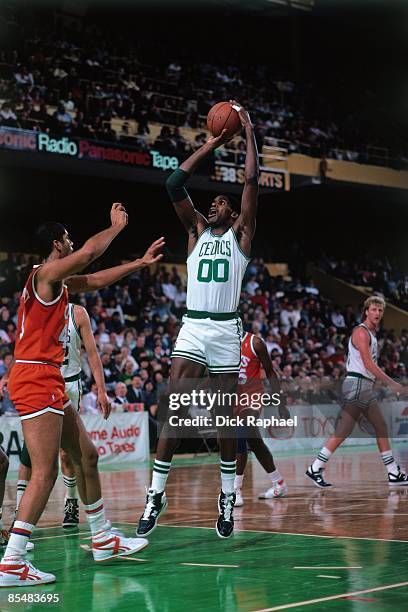 Robert Parish of the Boston Celtics shoots a jumper against the Cleveland Cavaliers during a game played in 1987 at the Boston Garden in Boston,...