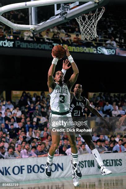 Dennis Johnson of the Boston Celtics goes up for a shot against Alvin Robertson of the San Antonio Spurs during a game played in 1987 at the Boston...