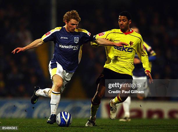 Jobi McAnuff of Watford battles for the ball with Chris Burke of Cardiff City during the Coca-Cola Championship match between Cardiff City and...