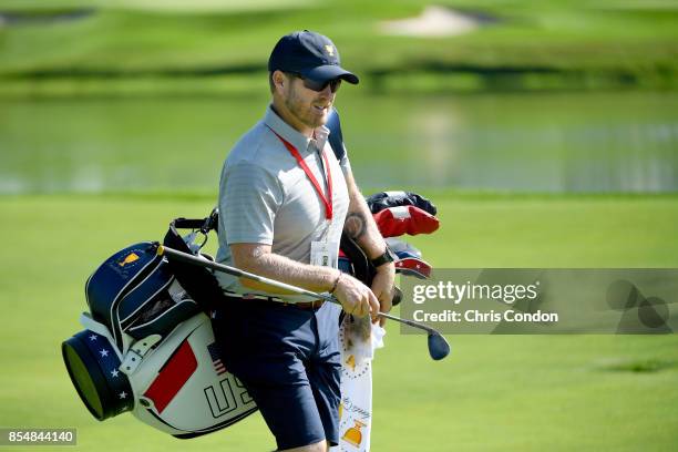 John Wood, caddie to Matt Kuchar of the U.S. Team looks on during a practice round prior to the start of the Presidents Cup at Liberty National Golf...