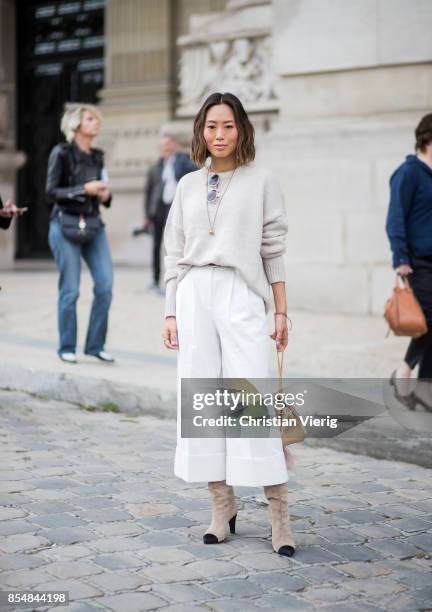 Aimee Song wearing white cropped pants, knit is seen outside Maison Margiela during Paris Fashion Week Spring/Summer 2018 on September 27, 2017 in...