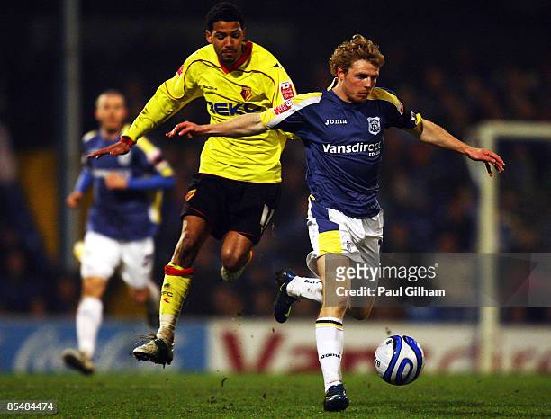 Jobi McAnuff of Watford battles for the ball with Chris Burke of Cardiff City during the Coca-Cola Championship match between Cardiff City and...