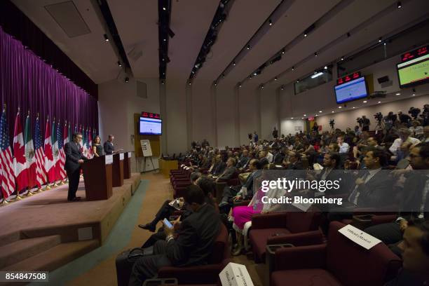 Ildefonso Guajardo Villarreal, Mexico's secretary of economy, top left, speaks attendees listen during a press conference on third round negotiations...