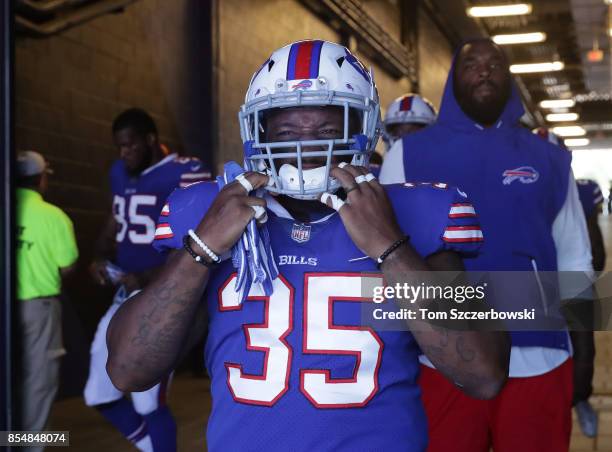 Mike Tolbert of the Buffalo Bills walks onto the field through the tunnel before the start of NFL game action against the Denver Broncos at New Era...