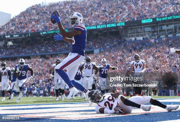 Andre Holmes of the Buffalo Bills celebrates as he scores a touchdown during NFL game action as Bradley Roby of the Denver Broncos tries to tackle...