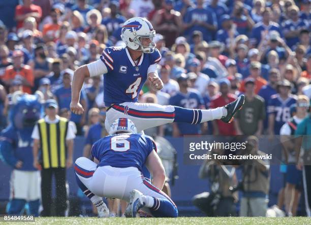 Stephen Hauschka of the Buffalo Bills kicks a field goal in the fourth quarter as Colton Schmidt holds for him during NFL game action against the...