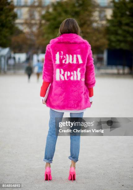 Alexandra Lapp wearing a fake fur jacket in pink from Jakke with a Faux Real statement on the back, red cashmere jumper by Heartbreaker with golden...