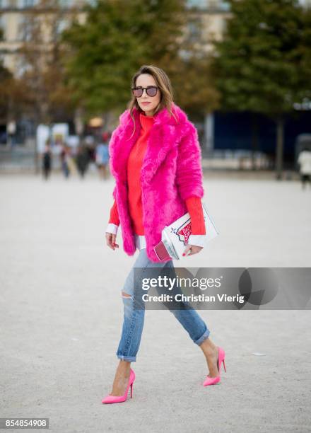 Alexandra Lapp wearing a fake fur jacket in pink from Jakke with a Faux Real statement on the back, red cashmere jumper by Heartbreaker with golden...