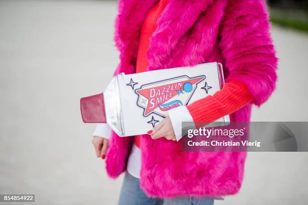 Alexandra Lapp wearing a fake fur jacket in pink from Jakke with a Faux Real statement on the back, red cashmere jumper by Heartbreaker with golden...