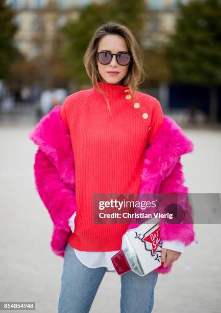 Alexandra Lapp wearing a fake fur jacket in pink from Jakke with a Faux Real statement on the back, red cashmere jumper by Heartbreaker with golden...