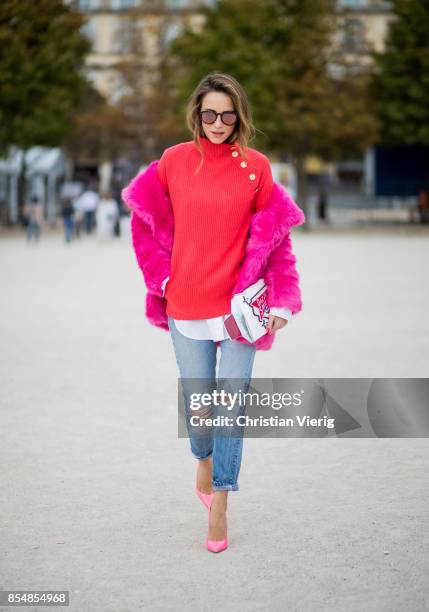 Alexandra Lapp wearing a fake fur jacket in pink from Jakke with a Faux Real statement on the back, red cashmere jumper by Heartbreaker with golden...