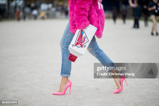 Alexandra Lapp wearing a fake fur jacket in pink from Jakke with a Faux Real statement on the back, red cashmere jumper by Heartbreaker with golden...