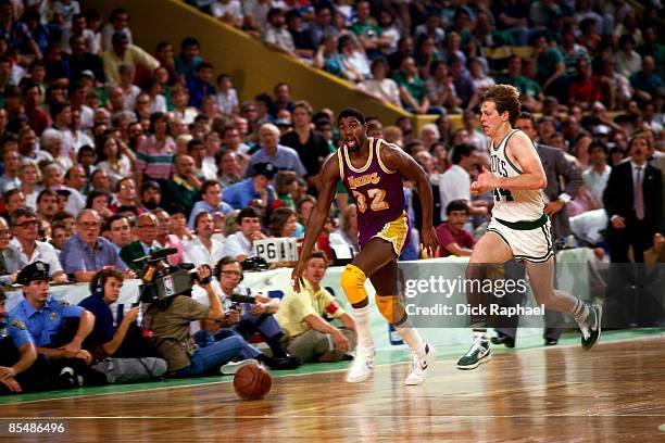 Magic Johnson of the Los Angeles Lakers moves the ball up court against Danny Ainge of the Boston Celtics during a game played in 1978 at the Boston...