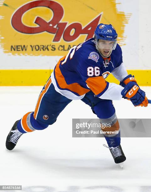 Nikolai Kulemin of the New York Islanders plays in a game against the New Jersey Devils at Nassau Veterans Memorial Coliseum on December 15, 2014 in...