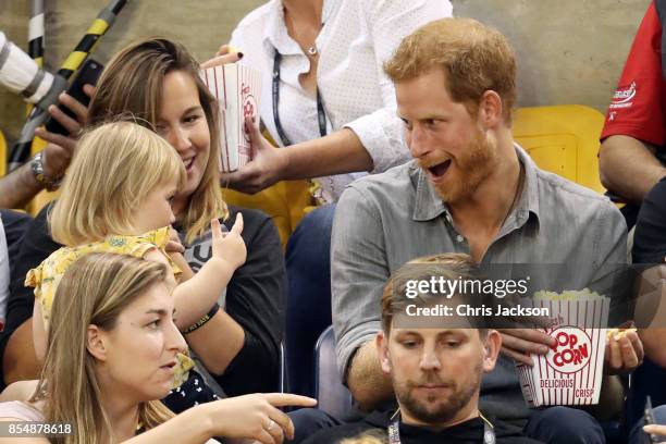 Prince Harry sits with David Henson's wife Hayley Henson and daugther Emily Henson at the Sitting Volleyball Finals during the Invictus Games 2017 at...